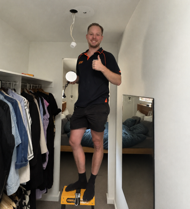Electrician Installing Chandelier